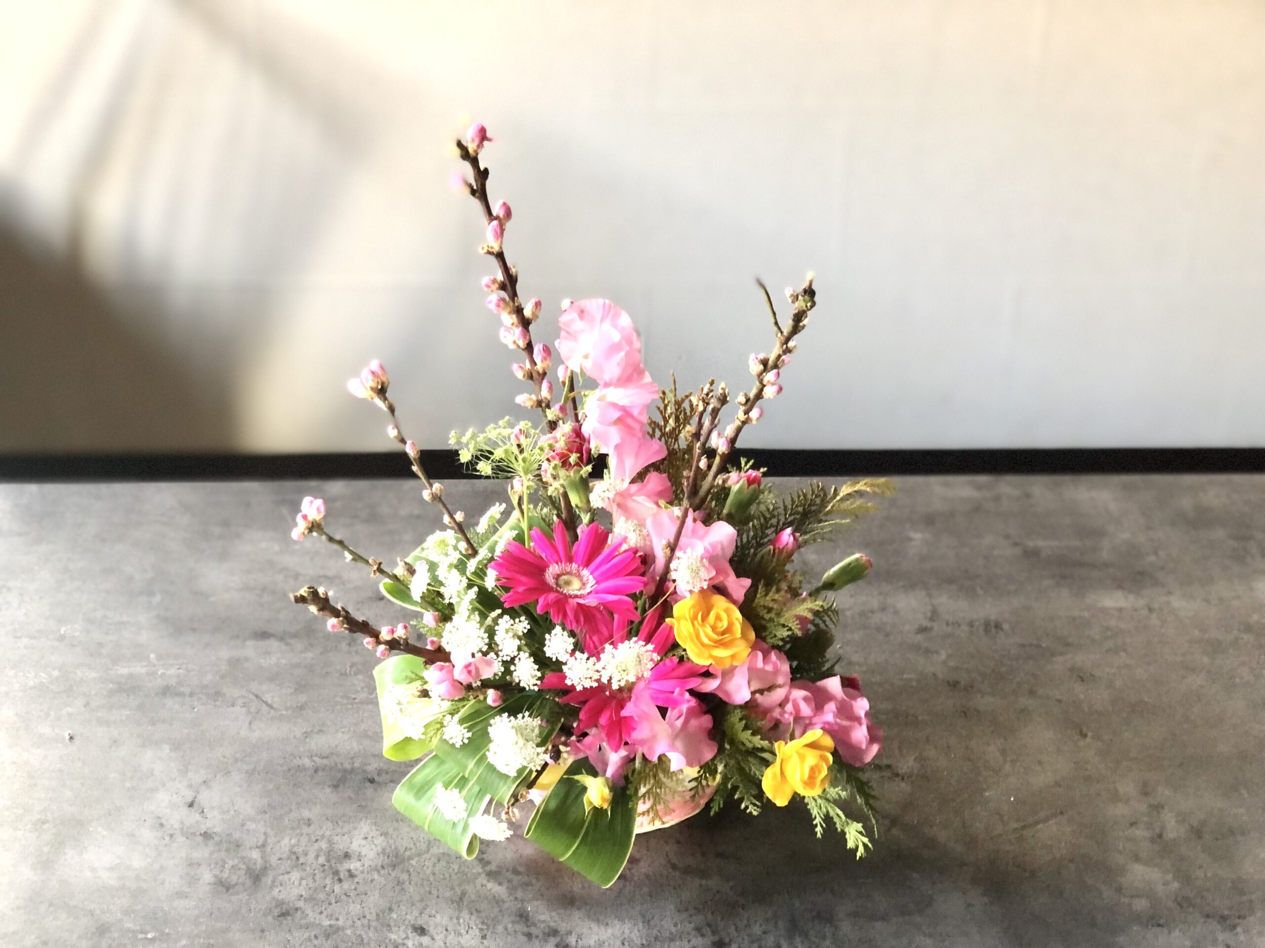 ひな祭りのアレンジメント　桃の花とガーベラ、スイトピーでピンク系に